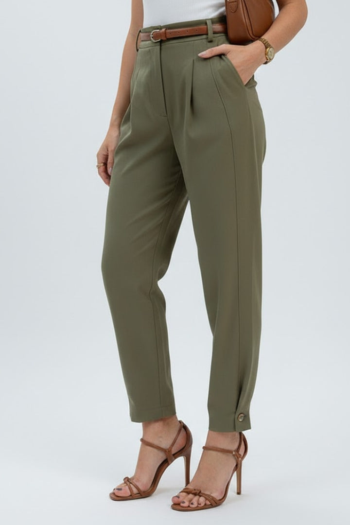 Detail shot of women's high-waisted pleated tapered pants, highlighting sophisticated design.