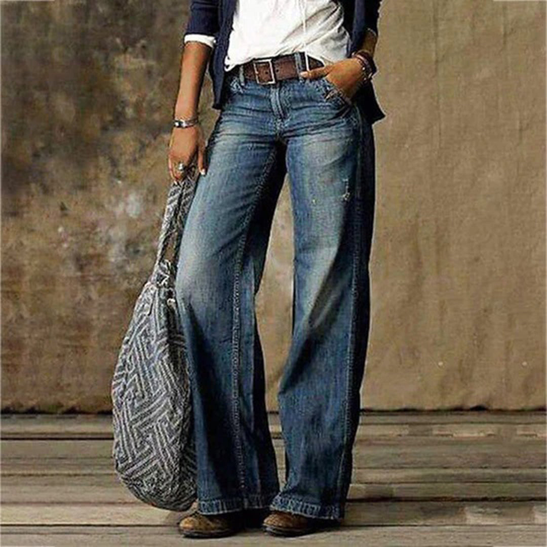 Trendy women's high-rise wide-leg jeans, made from comfortable denim, displayed on a hanger.