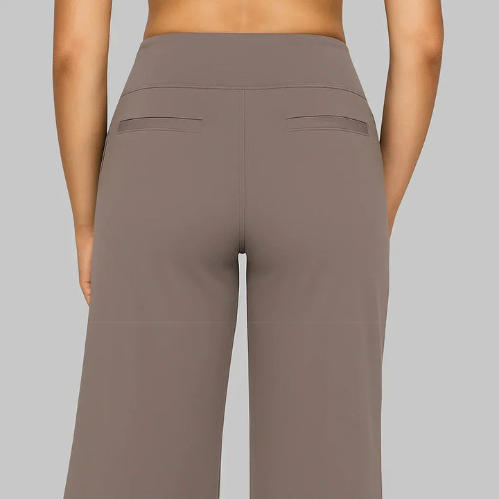 Versatile women's high-waisted wide-leg pants featuring pockets, great for travel & everyday comfort.
