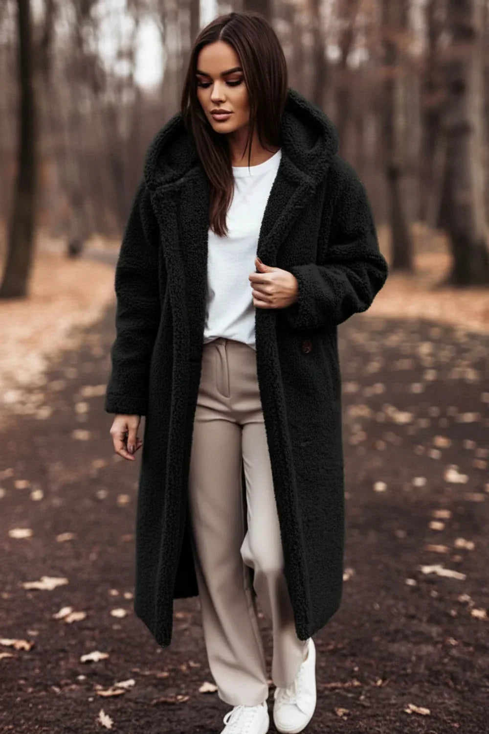 Plush teddy bear coat for women, featuring a cozy hood. Perfect oversized winter outerwear for warmth & chic style.