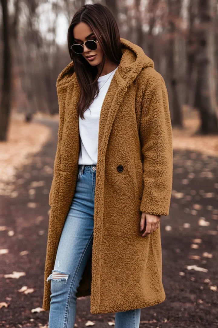 Luxurious women's teddy coat with hood. Oversized, plush winter fashion for warm, chic, and cozy outerwear.