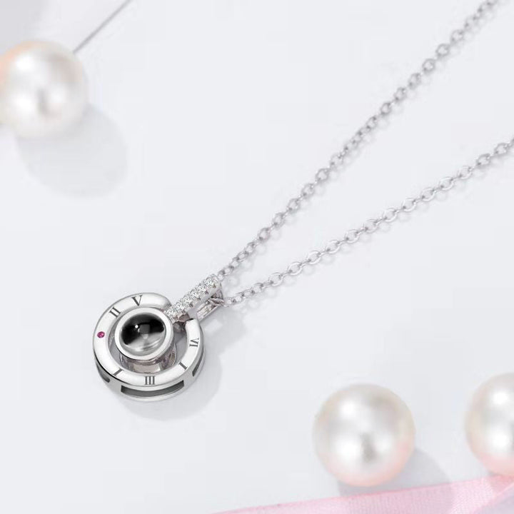 Gift box containing a rose gold '100 Languages I Love You' projection necklace, ready for gifting.