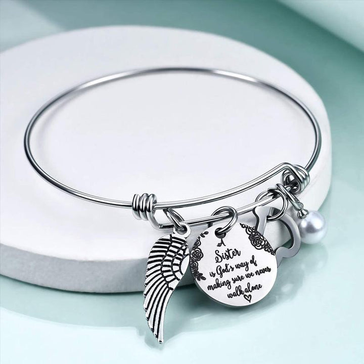 Adjustable stainless steel women's bangle with inspirational 'Sister' message