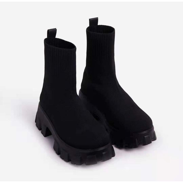 Black women's chunky platform ankle boots with strong grip, ideal urban footwear for winter.
