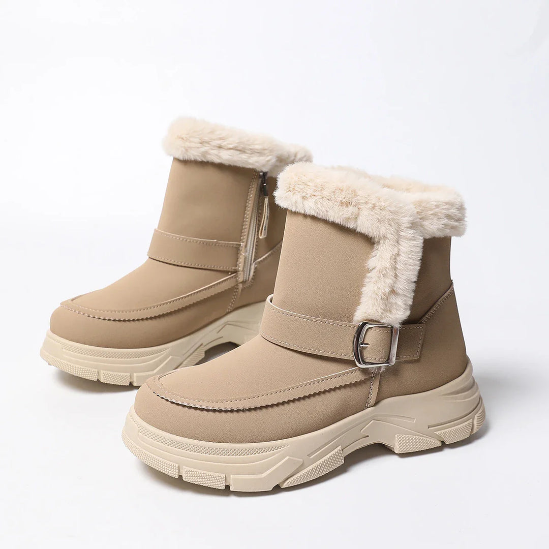 Lifestyle image of women's khaki boots with faux fur, walking in snowy landscape
