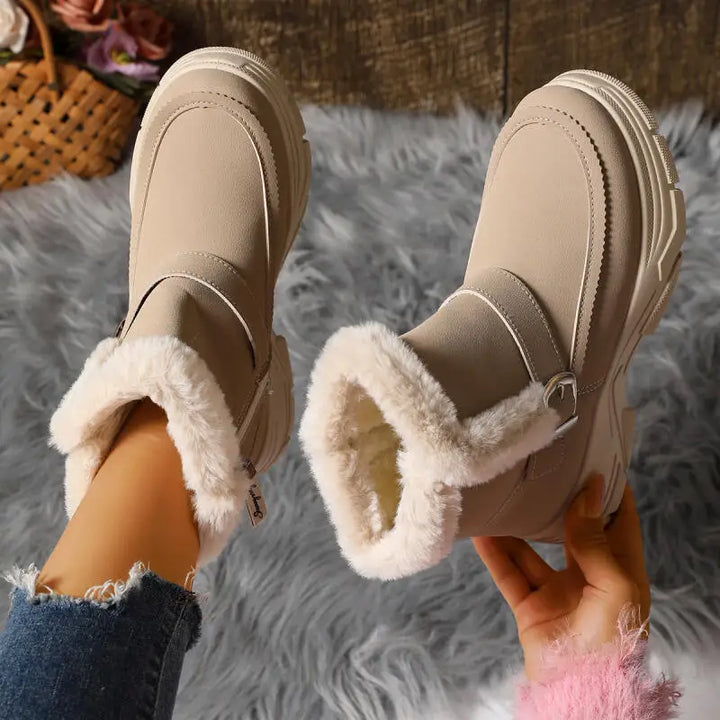 Detail of the buckle closure on women's faux fur lined gray winter boots