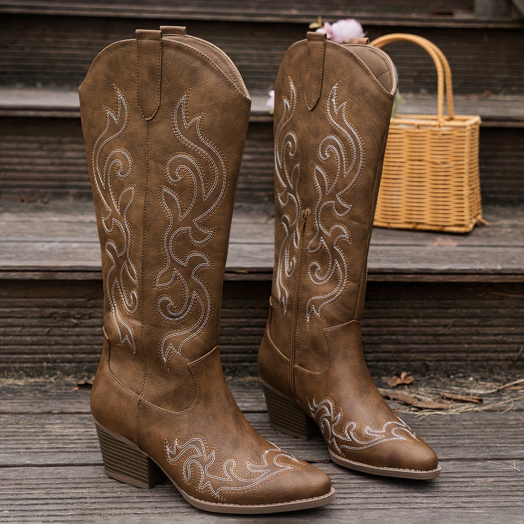 White women's fashion boots. Knee-high cowboy style with block heel and pointed toe.