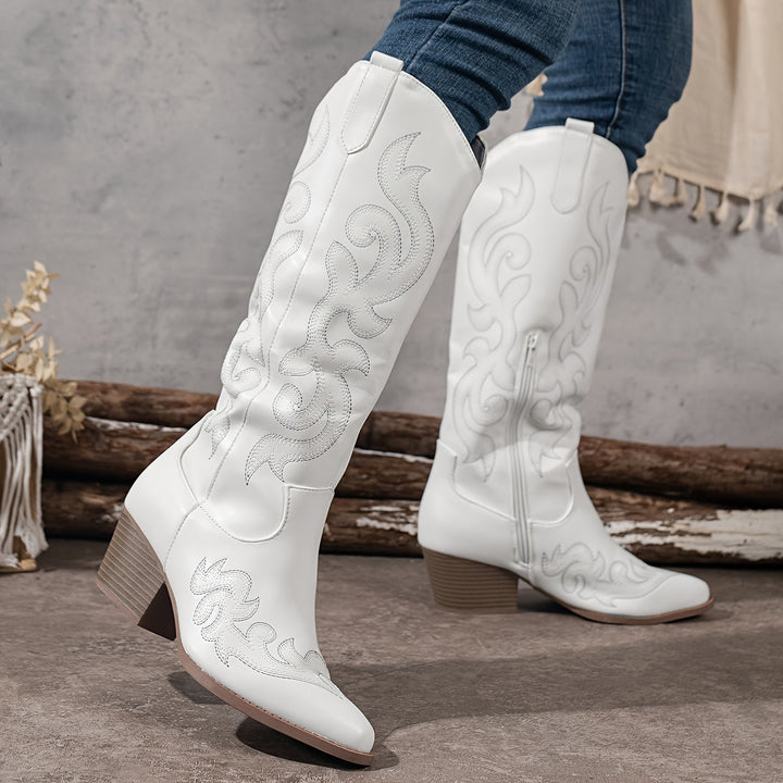 White fashion cowboy boots. Women's knee-high, block heel, with a trendy pointed toe.