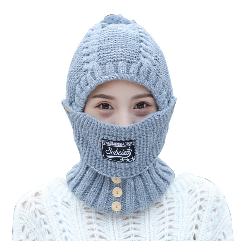 Overhead view of a women's knitted beanie, highlighting its ear protection feature and soft fabric.