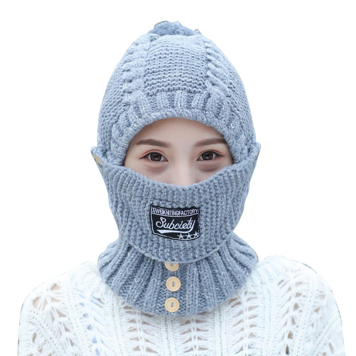 Overhead view of a women's knitted beanie, highlighting its ear protection feature and soft fabric.