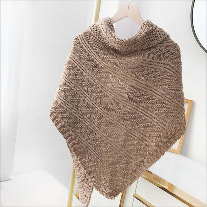 Studio shot of a women's knitted triangle shawl, showcasing its full shape