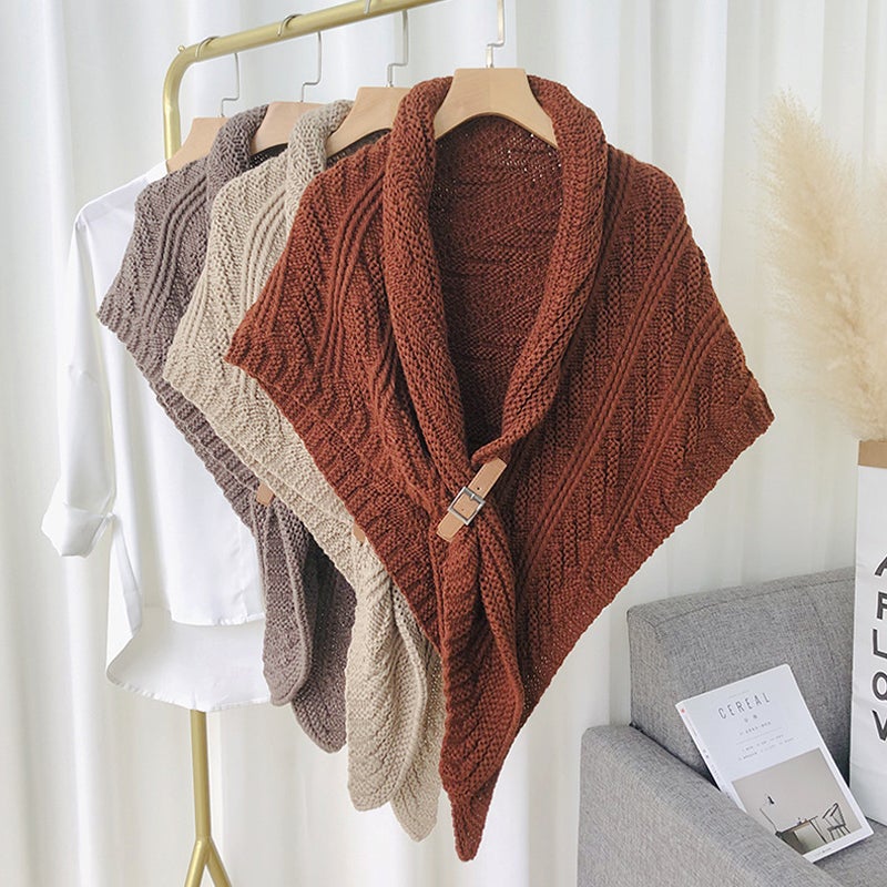 Close-up of the textured knit and buckle on a warm women's shawl