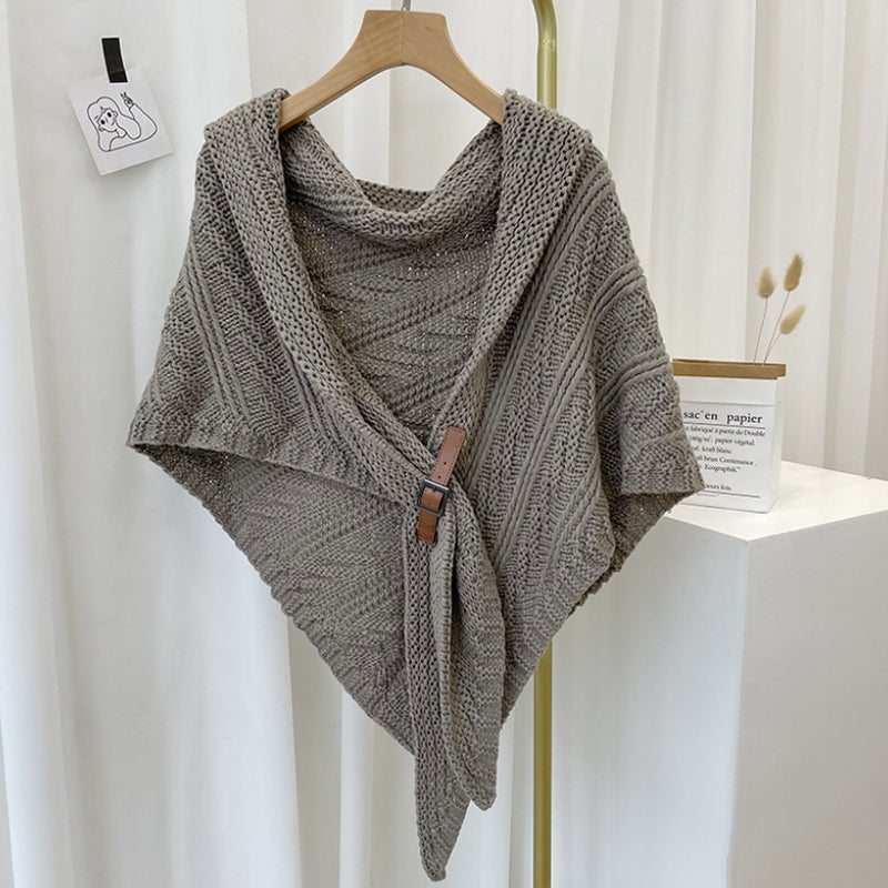 Woman's knitted triangle poncho, showcasing it as a stylish outer layer