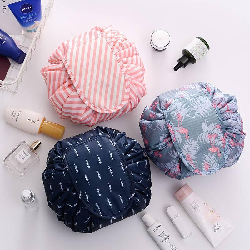 Women's lay-flat drawstring cosmetic pouch in open position, showing ample storage for makeup and brushes.