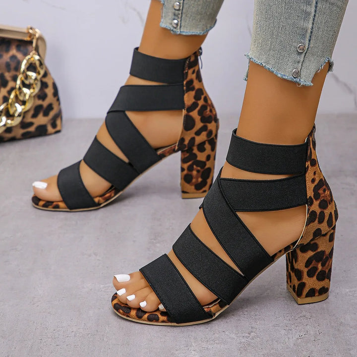 Side view of women's leopard print block heel sandals with elasticated ankle straps. Chic womens heels.