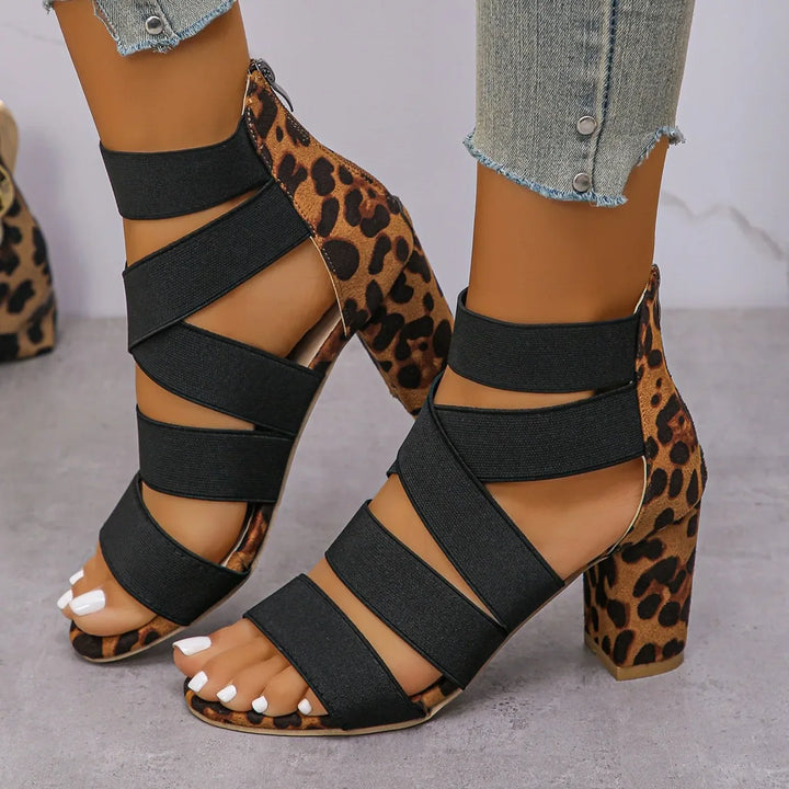 Elegant women's leopard print block heel sandals with elastic straps, offering both style and comfort.