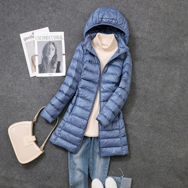 Elegant women's long puffer coat, offering warmth, windproof protection, and water resistance for winter.