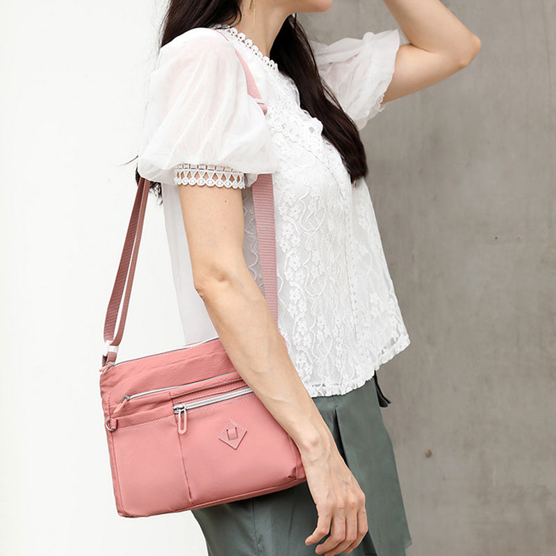 Women's lightweight multi-pocket shoulder bag in black, ideal for travel and daily use