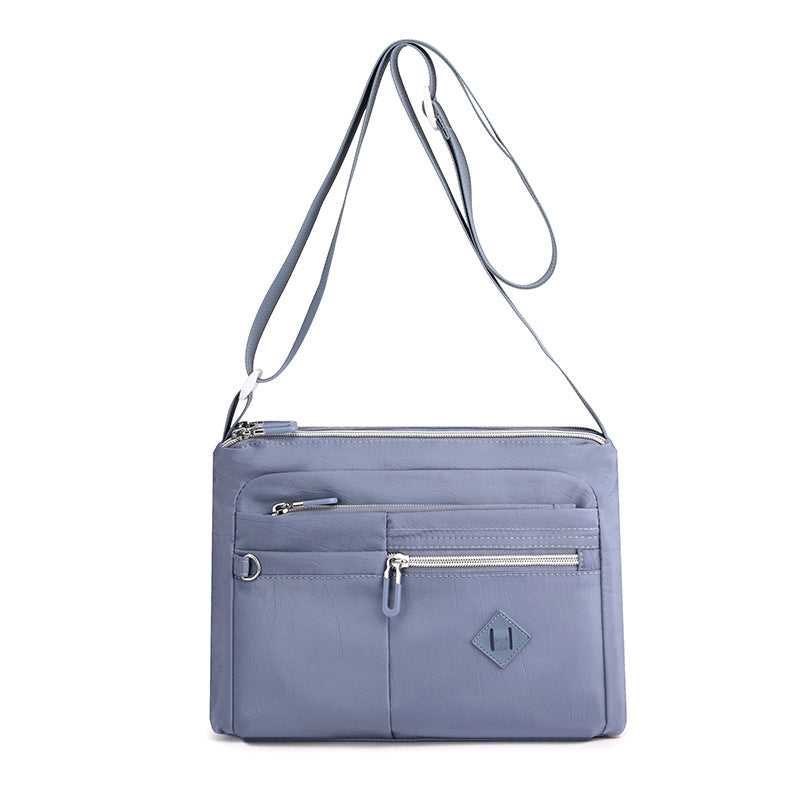 Backside of the multi-pocket crossbody bag for women, with an additional zip pocket
