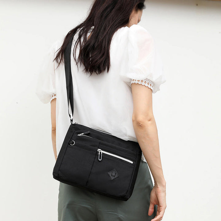 Stylish women's nylon shoulder bag with multiple pockets, perfect for organizing essentials