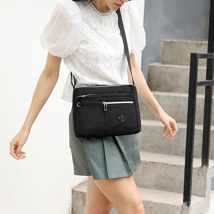 Side view of the lightweight nylon shoulder bag for women, highlighting its slim profile