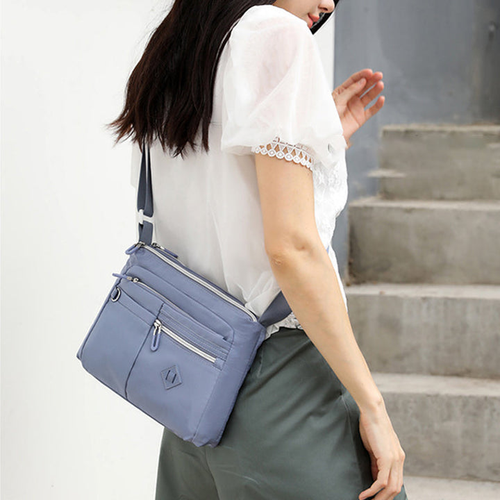 Close-up of the waterproof fabric on the women's shoulder bag, showing texture
