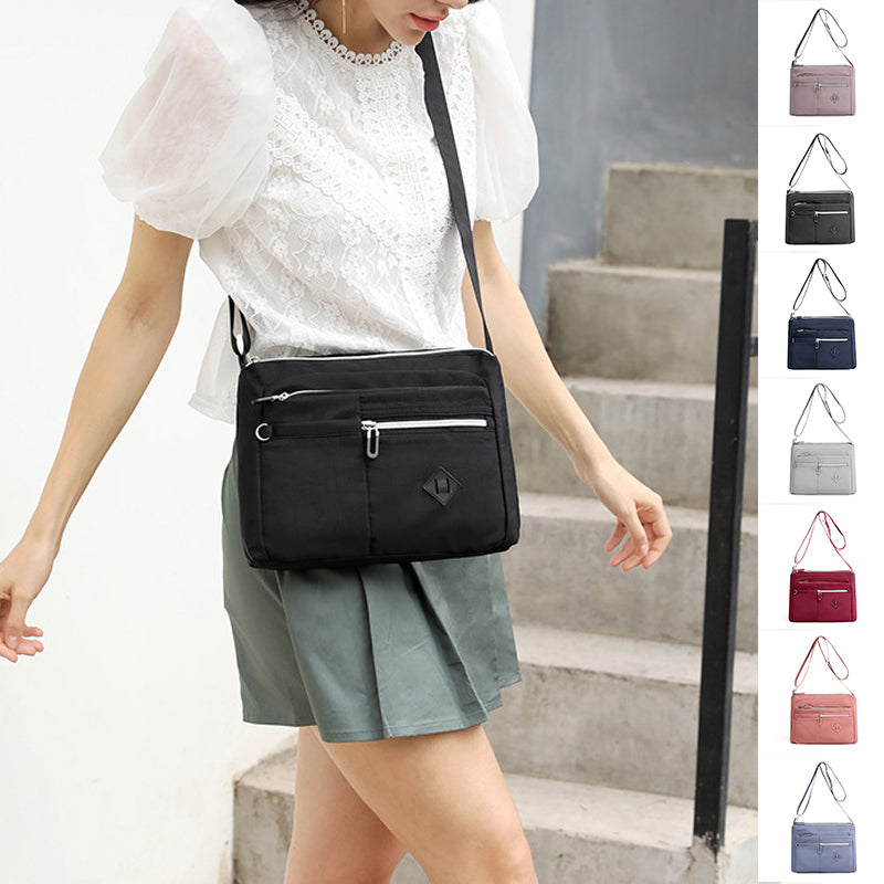 Inside view of the multi-pocket shoulder bag, revealing organized compartments