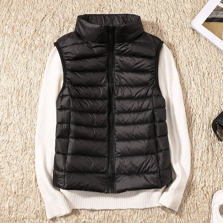 Women's lightweight quilted vest for sleek, stylish outerwear. Perfect layering piece.