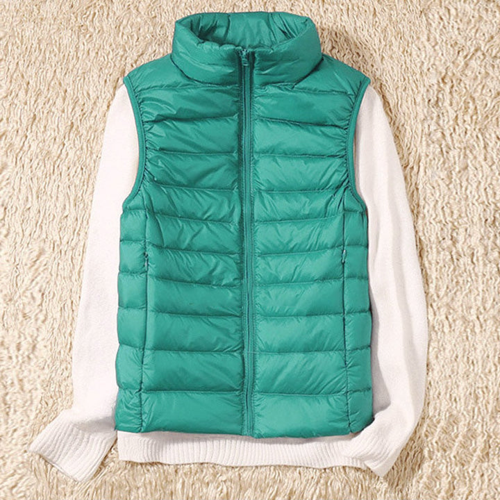 Lightweight zip vest for women, featuring a chic quilted design. Ideal for transitional seasons.