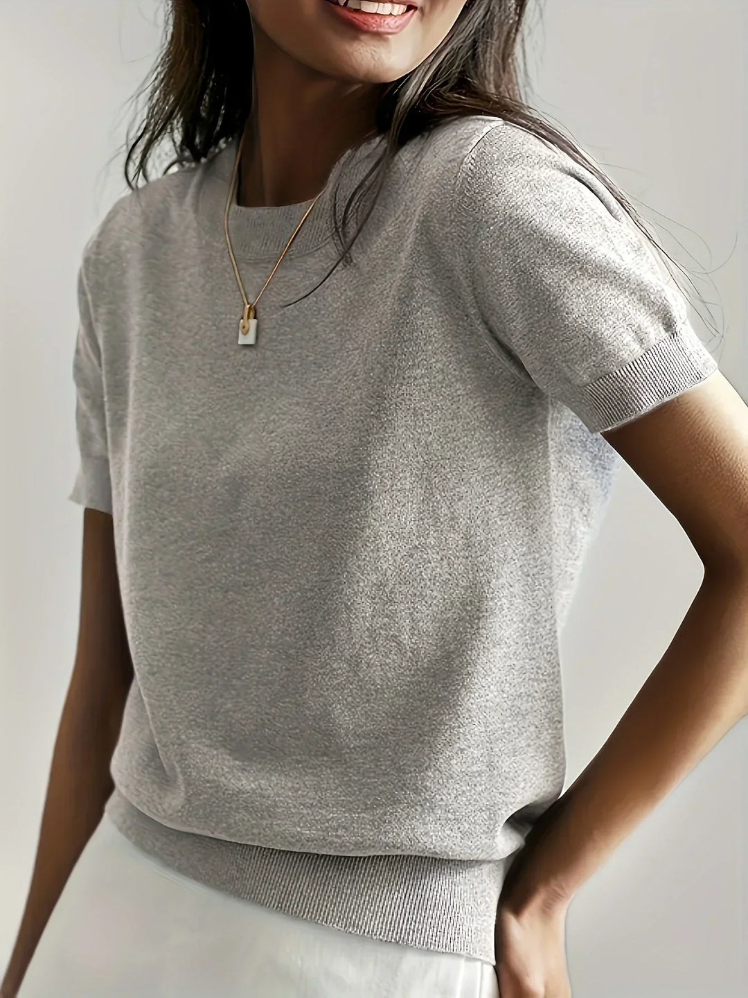 Lightweight knit short sleeve women's sweater, a breathable casual pullover for spring/summer.