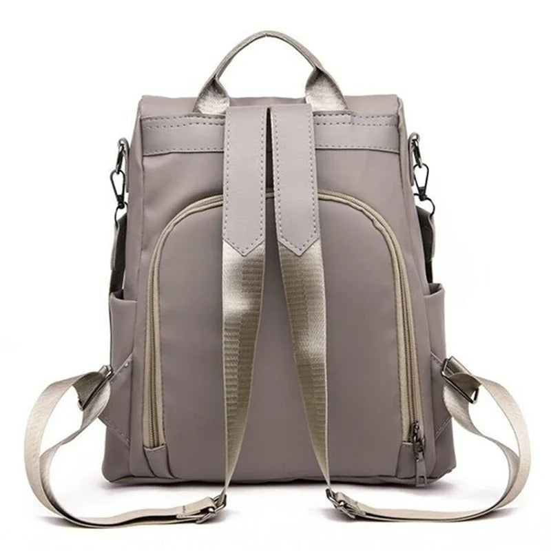 Fashionable women's lightweight nylon travel backpack. Offers multi-way carry: shoulder, crossbody, or back.