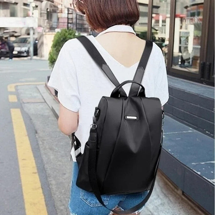 Modern multi-way nylon backpack for women; lightweight, water-resistant, ideal for travel & urban adventures.