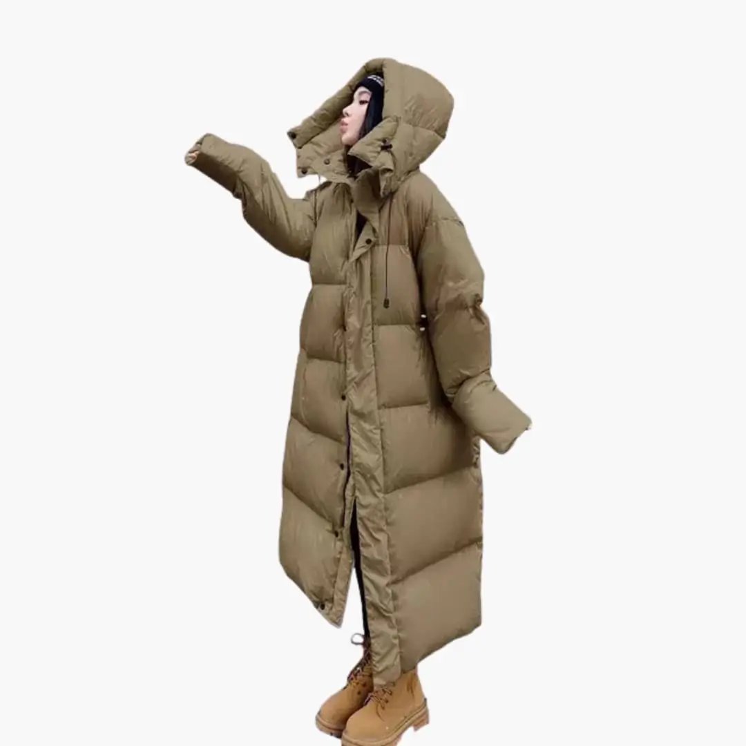 Stylish women's oversized long puffer jacket, quilted and hooded, providing warmth for winter fashion.