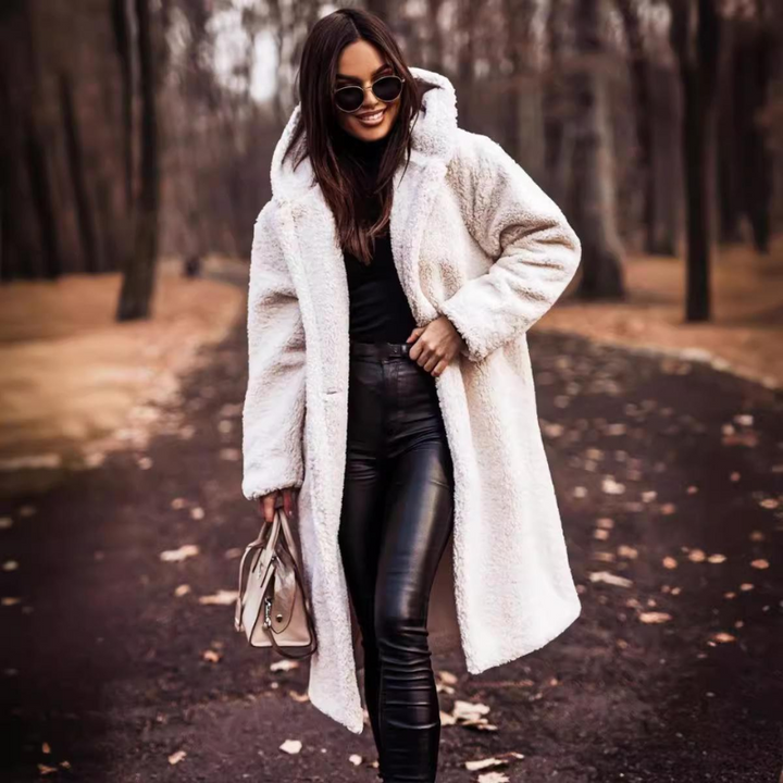 Stylish women's long hooded winter coat, a warm teddy bear outerwear piece for fall and cold weather.