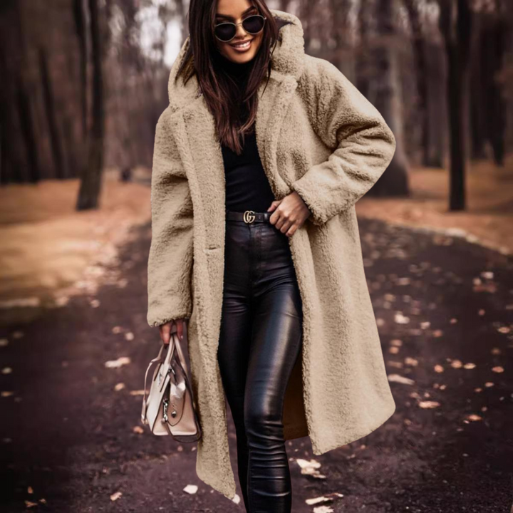 Comfortable long teddy coat for women with a hood, providing warm and cozy fashion throughout winter.