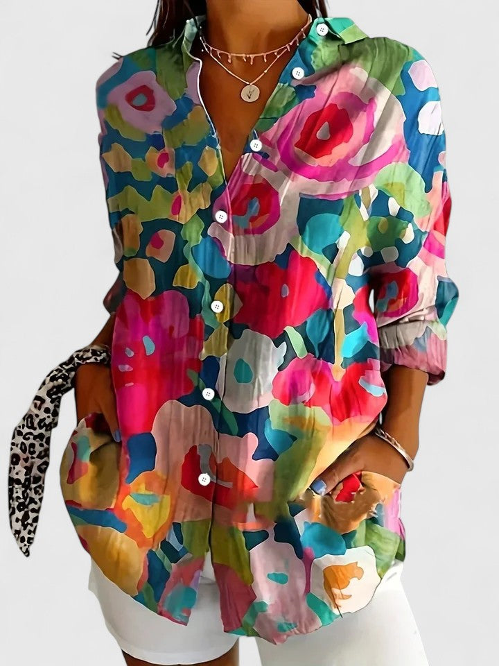 Casual women's button down blouse featuring a unique abstract floral print. Ideal for summer and spring.