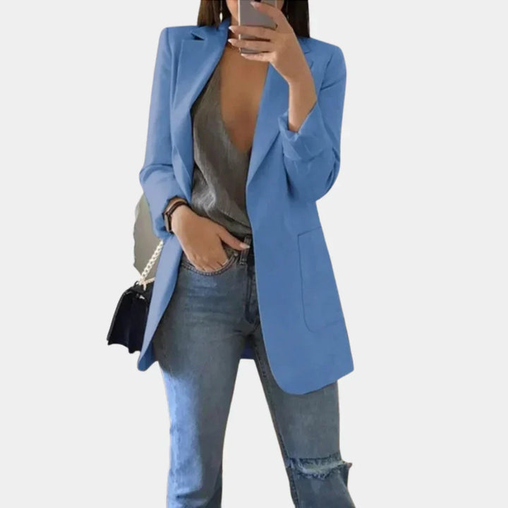 Sophisticated women's long slim fit blazer in a solid color, embodying modern professional fashion and elegance.