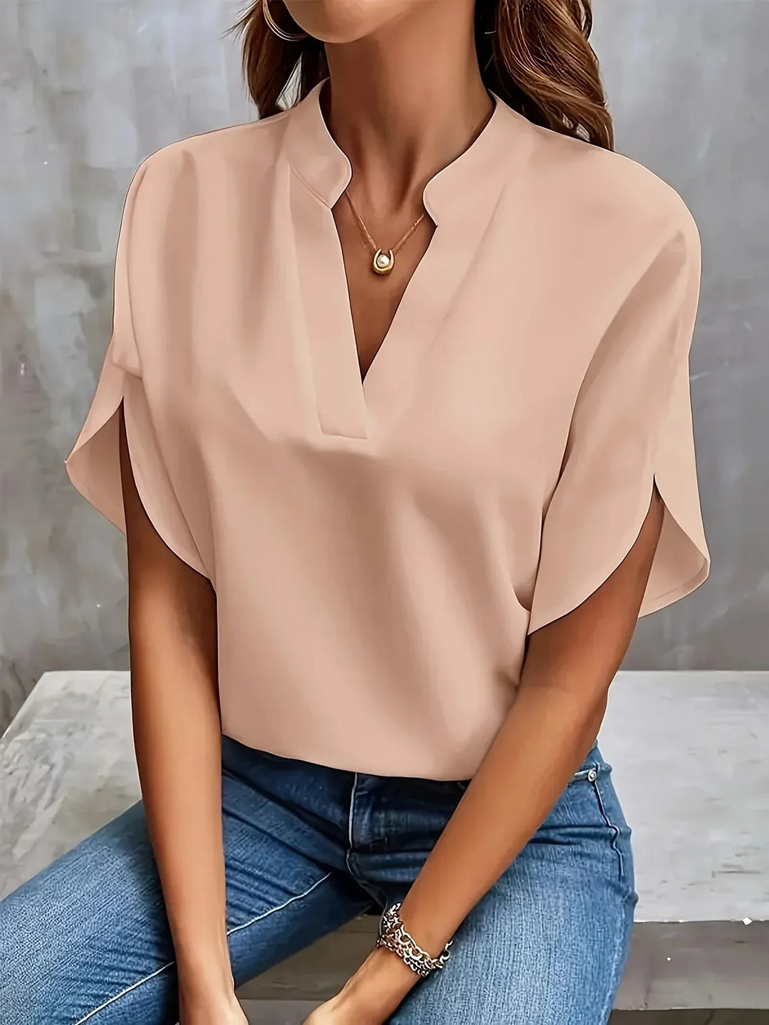 Chic women's short sleeve V-neck blouse, loose fit design for an elegant and professional office look.