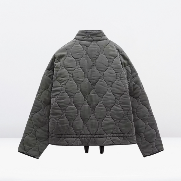 Gray women's quilted jacket with adjustable drawstring & zipper. Warm, casual fall/winter outerwear for women.