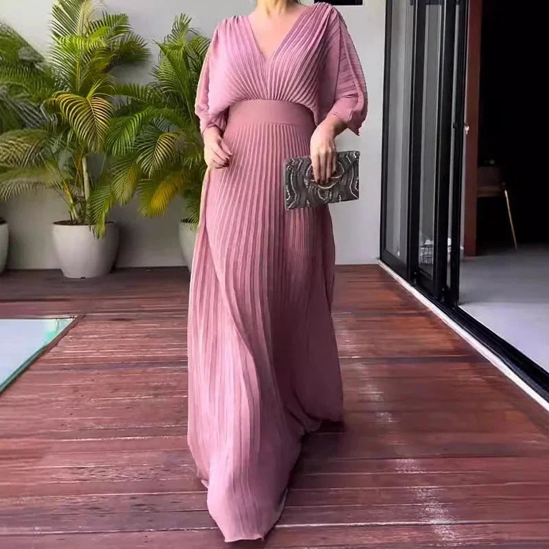 Flowy pleated V-neck kaftan maxi dress for women, an elegant and comfortable summer wedding guest outfit.