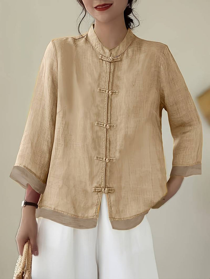 Professional women's office blouse, mandarin collar, frog buttons, tailored for a sharp look.