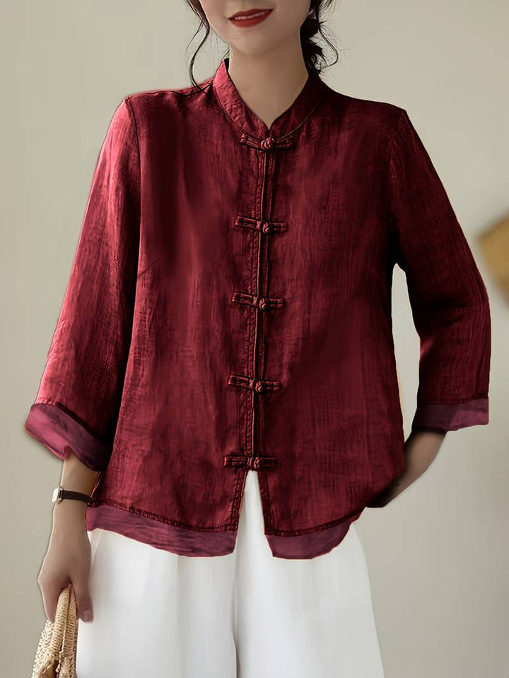 Elegant women's casual blouse, mandarin collar, unique frog button closure, versatile design.
