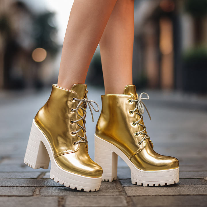 Close-up of metallic platform boots showing lace-up detail & textured material, women's fashion.
