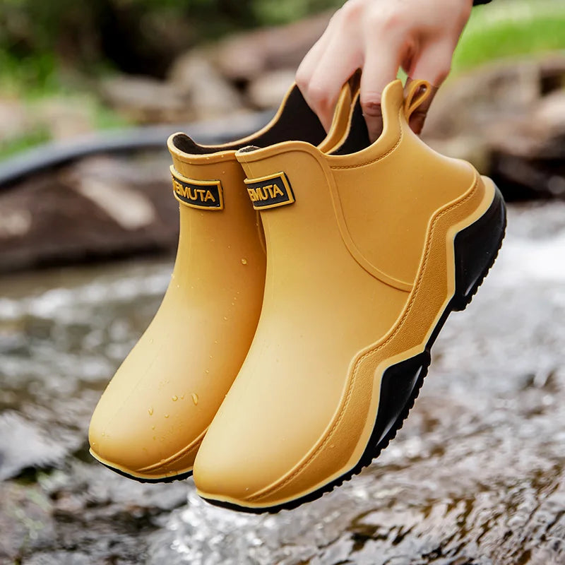 Durable women's waterproof mid-height rain boots, anti-slip sole for safety in wet conditions.