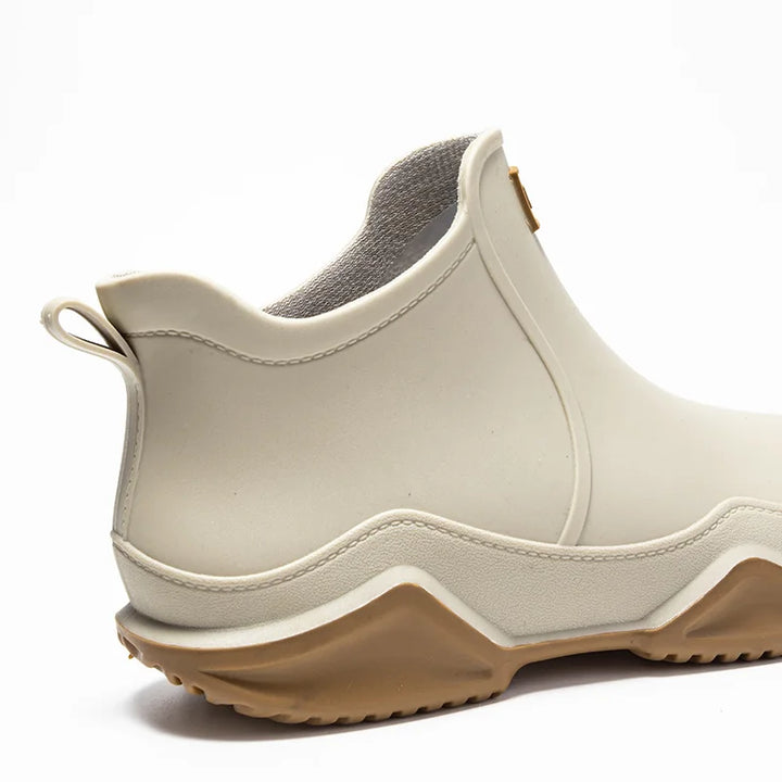 Women's mid-height rain boots, fully waterproof with sturdy anti-slip sole for wet autumn conditions.