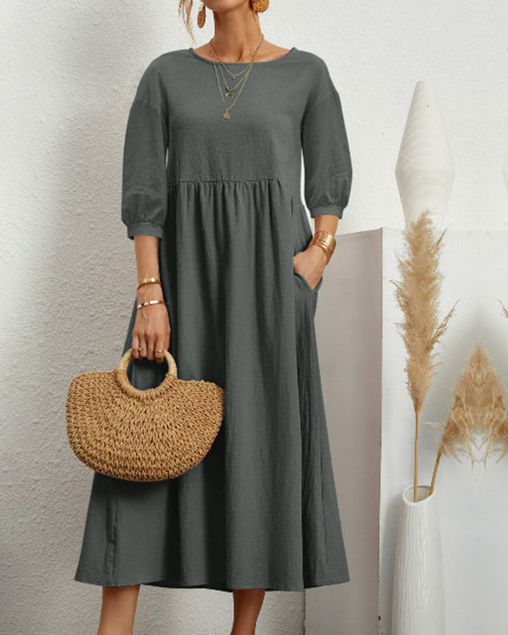 Women's midi dress with round neckline and elegant lantern sleeves for versatile wear.