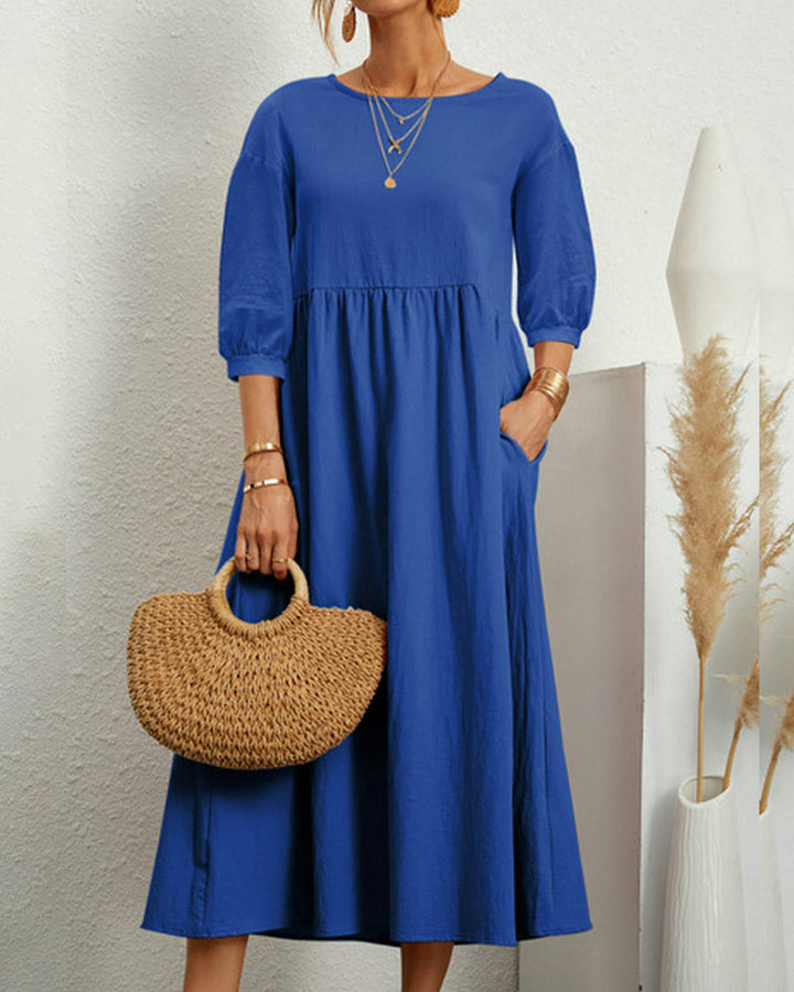 Stylish women's midi dress featuring a round neck, loose fit, and chic lantern sleeves.