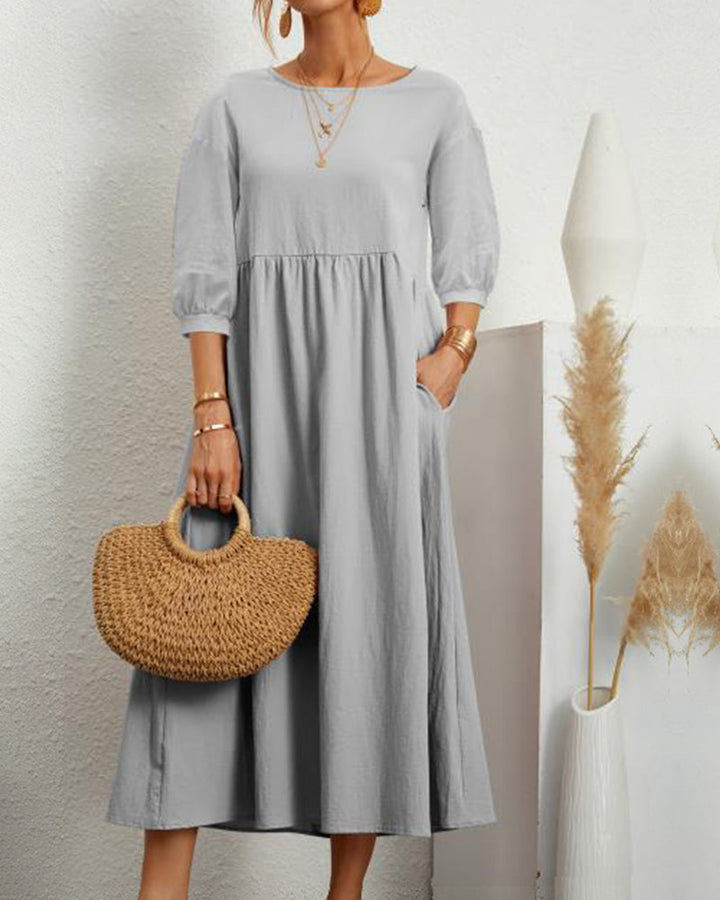 Casual spring/summer women's midi dress with a round neckline and trendy lantern sleeves.