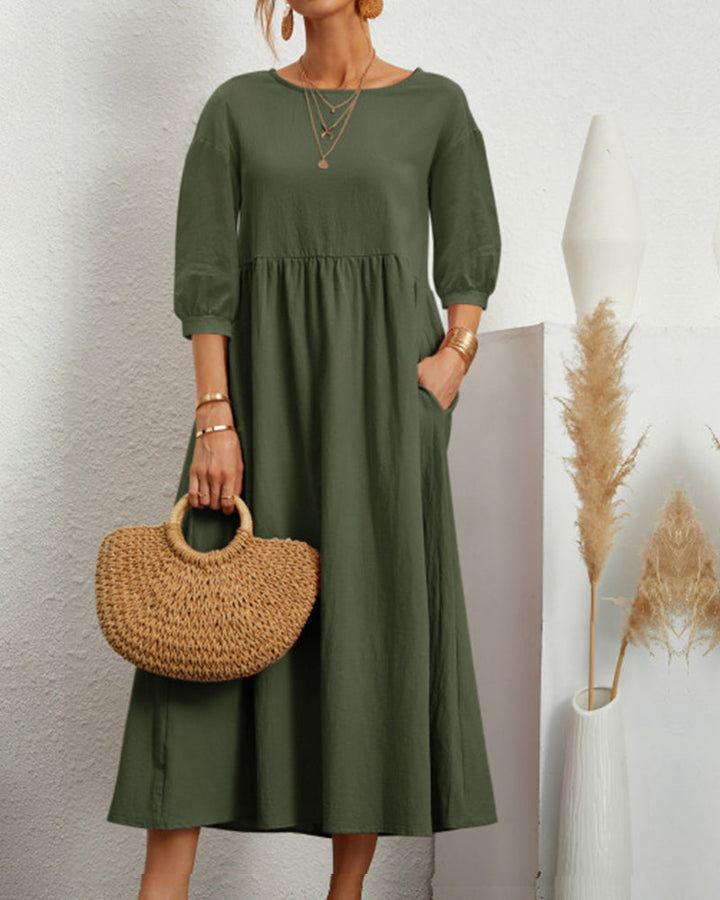 Elegant women's midi dress, perfect for autumn, with round neck and fashionable lantern sleeves.
