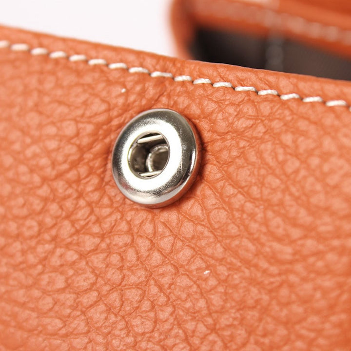 Multiple colorful mini leather coin purses displayed, showcasing variety for fashion